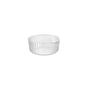 A clear round Exclusiva glass serving bowl with a multifaceted texture.