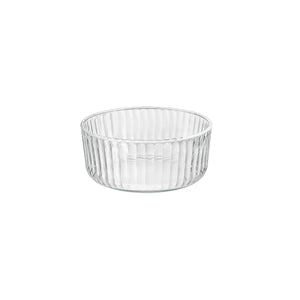 A clear round Exclusiva glass serving bowl with a multifaceted texture.