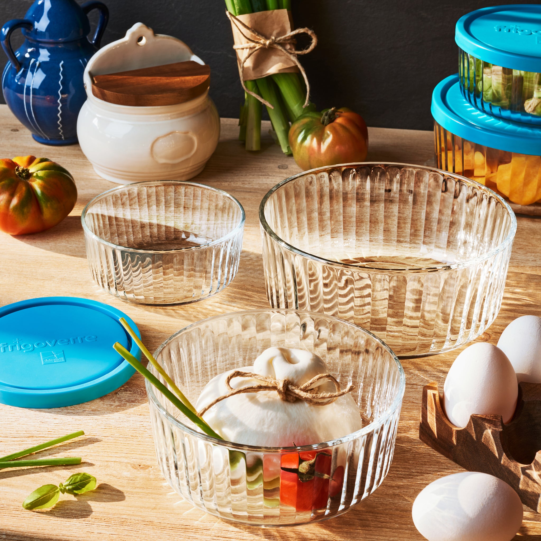 Clear Brilliante glass bowls with decorative items on a wooden table.