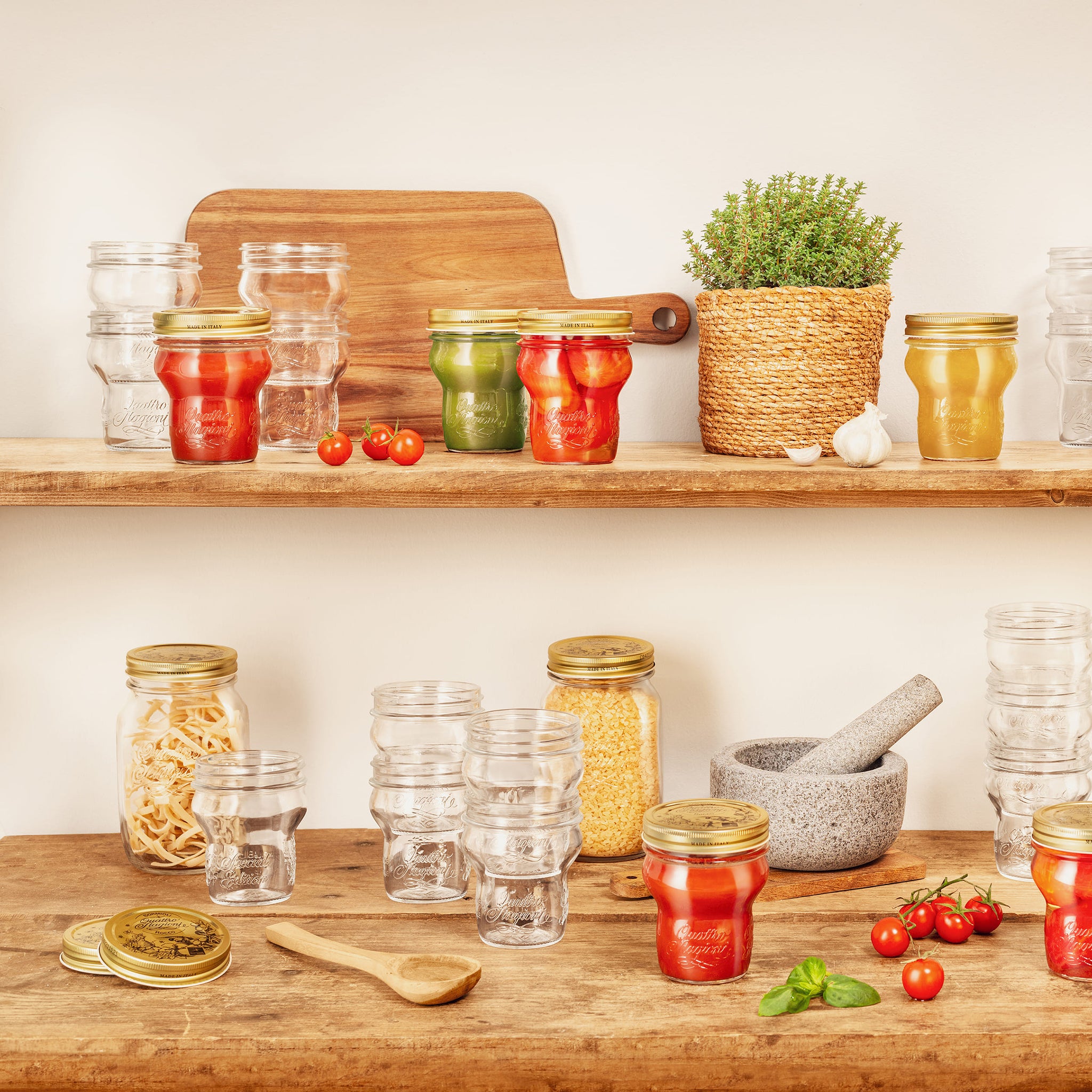 Kitchen shelves with Quattro Stagioni special edition jars of preserved foods and fresh ingredients.