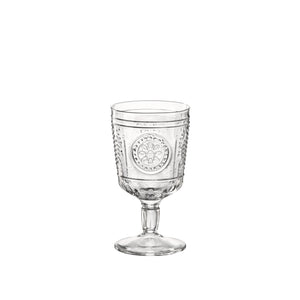 A clear glass with a Victorian-inspired design, featuring intricate embossed patterns and a wide mouth.